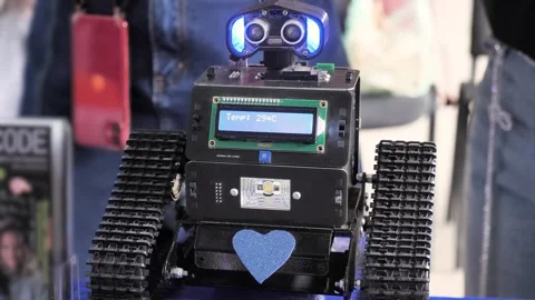 Cute crawler robot with blue lights and heart Stock Footage 297549420