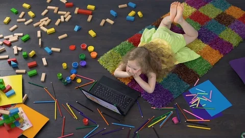 Cute curly girl using educational software on laptop, learning numbers at home Stock Footage 80652804