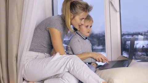 Cute daughter with her mom using computer Stock Footage 85118704