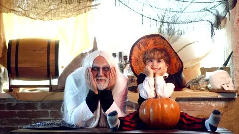 Cute Devil with Witch hat posing with pumpkin over Halloween background Stock Footage 140207475