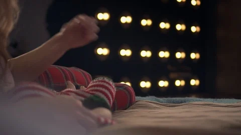 Cute dog in red jacket is trying to jump on bed for three times. Then Stock Footage 86567816