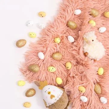 Cute Easter arrangement with pastel pink fluffy fur and eggs and decorations  写真素材