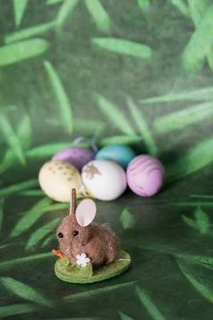 Cute easter bunny and colored eggs, green background Stock Photos