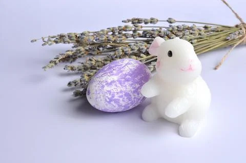 Cute Easter Bunny. Easter egg on a purple background. Lavender. Easter. Stock Photos