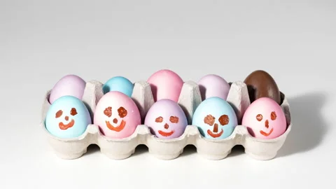 Cute easter eggs with funny faces in box... | Stock Video | Pond5