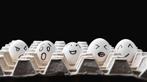 Cute easter eggs with funny faces in box at black background. Stop motion. Stock Footage 303237075