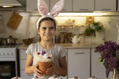 Cute Easter eggs with painted smiley faces and lilac flowers. Celebration. Funny Stock Photos