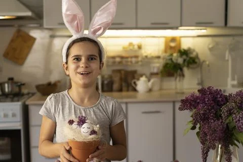 Cute Easter eggs with painted smiley faces and lilac flowers. Celebration. Funny Stock Photos