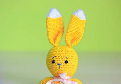 A cute Easter yellow soft bunny toy on yellow background. Happy Easter concep Stock-Fotos