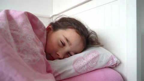 Cute elementary age child resting on cozy bedding Stock Footage 152097063