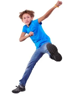 Cute elementary boy  jumping and dancing over white Stock Photos