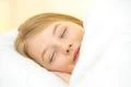 The cute face of the young girl on the pillow Photo