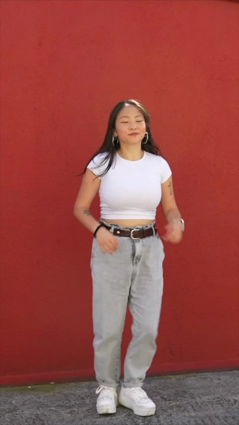 Cute female dancer raising arm performing urban choreography Stock Footage 299810779