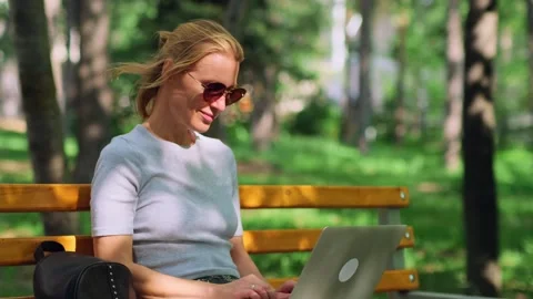 Cute female freelancer making remote work outdoors. 動画素材 246334260