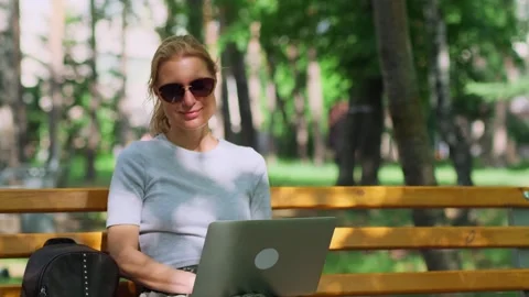 Cute female freelancer making remote work outdoors. Stock-Footage 250171214