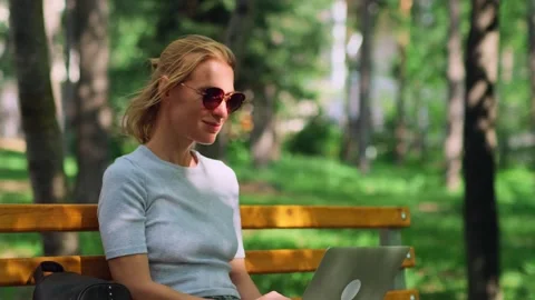 Cute female freelancer making remote work outdoors. Stock Footage 261781021