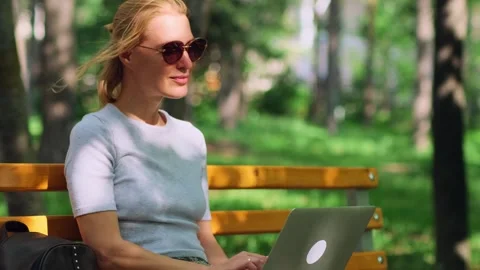 Cute female freelancer making remote work outdoors. Stock-Footage 263512650