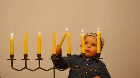 Cute few years old boy ignite Menorah Stock-Footage 104508220