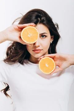 Cute Fit Model Posing With Halves of Citruses Stock Photos
