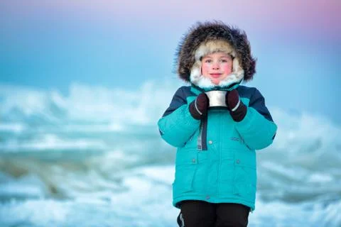 Cute five years old boy drinking hot tea in winter Stock Photos