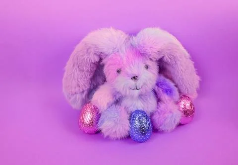 Cute fluffy Easter bunny with colourful Easter eggs Stock Photos