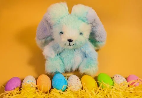 Cute fluffy Easter bunny with colourful Easter eggs Foto stock