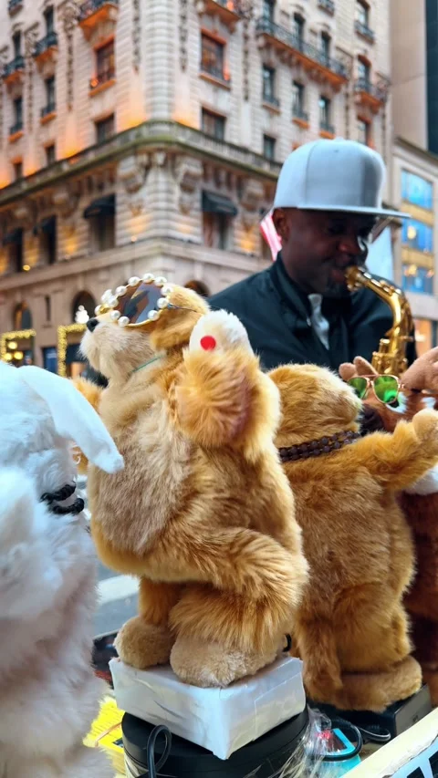 Cute fluffy electronic toys dancing in the street. Afro-American man in blue cap Stock Footage 328722178