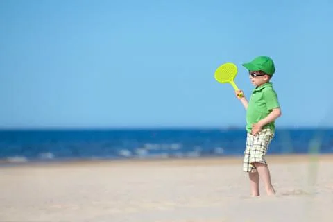 Cute four years old boy playing on tropical beach Stock Photos