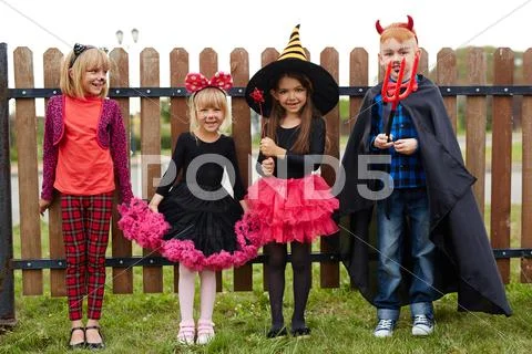 Cute friendly children in Halloween costumes Stock Photos