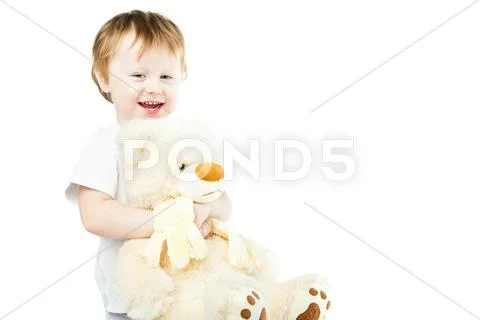 Cute funny infant baby girl with big toy bear Stock Photos