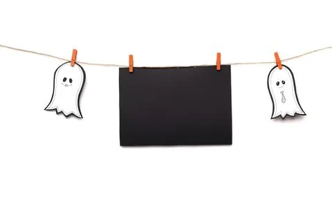 Cute ghost decorations hanging on a string with black board Stock Photos
