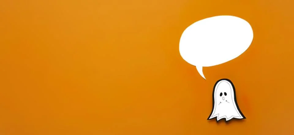 Cute ghost with speech bubble on orange background Stock Photos