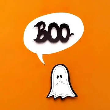 Cute ghost with speech bubble saying boo on orange background Stock Photos