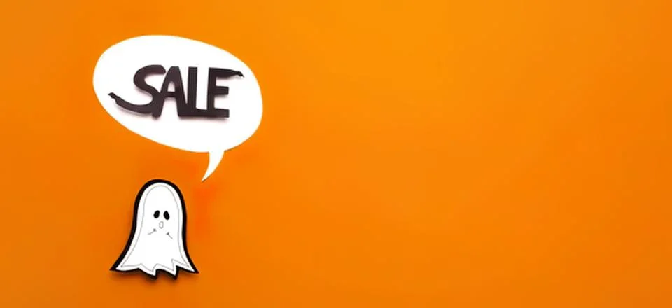 Cute ghost with speech bubble saying sale on orange background Stock Photos