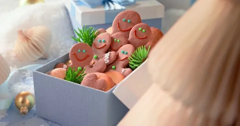 Cute gingerbread men rest in light blue present boxes. Stock Footage 347016848