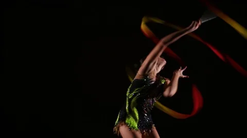 Cute girl athlete performs elements of rhythmic gymnastics with ribbon Stock Footage 104126424