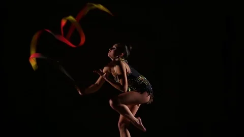 Cute girl athlete performs elements of rhythmic gymnastics with ribbon Stock Footage 104126431