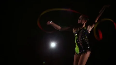 Cute girl athlete performs elements of rhythmic gymnastics with ribbon Stock Footage 104126442