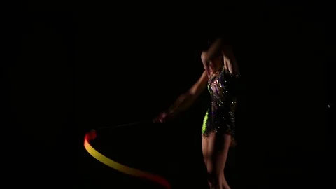 Cute girl athlete performs elements of rhythmic gymnastics with ribbon Stock Footage 104126444