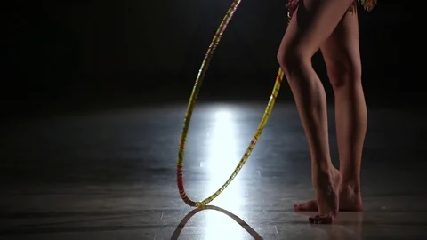Cute girl athlete performs elements of rhythmic gymnastics with hoop in gym Stock Footage 104126492
