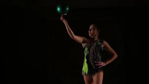 Cute girl athlete performs elements of rhythmic gymnastics with ball in gym Stock Footage 104126585