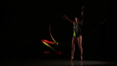 Cute girl athlete performs elements of rhythmic gymnastics with ribbon Stock Footage 104126692