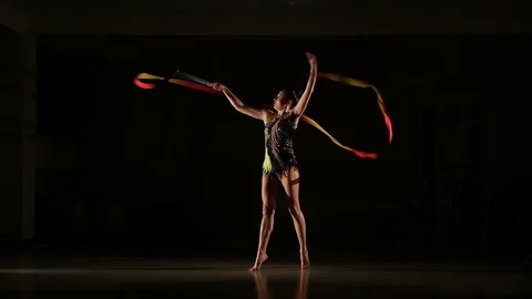 Cute girl athlete performs elements of rhythmic gymnastics with ribbon Stock Footage 104689618