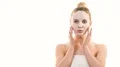 The cute girl with a clean mask touching the face on the white background 4k or 4k+ Resolution