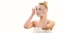 The cute girl with a clean mask touching the face on the white background 4k or 4k+ Resolution