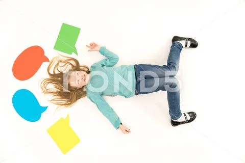 The cute girl gesture on the floor near the dialog signs. View from above Stock Photos