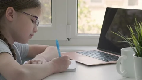 Cute girl in glasses handwrite study online using laptop at home, back to school Video stock 202480304