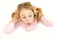 The cute girl grimace on the white background. View from above Photo