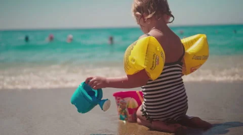 Cute Girl Having Fun on Beach and Playing with Sand Stock Footage 60383584