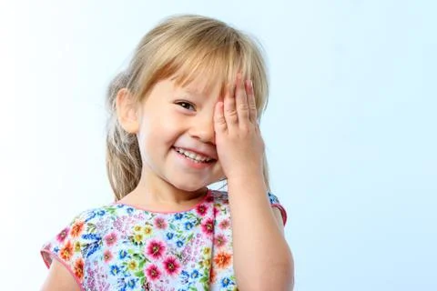 Cute girl hiding eye with hand. Stock Photos